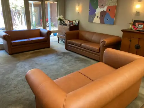 Close-up image of a reupholstered leather tan couches by Southside Upholstery Perth.